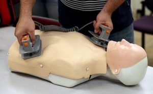 Man attemping to save a dying CPR dummy